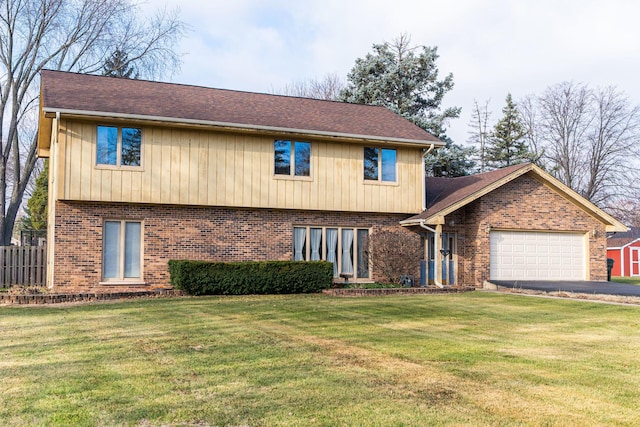 view of front of house with a garage and a front lawn