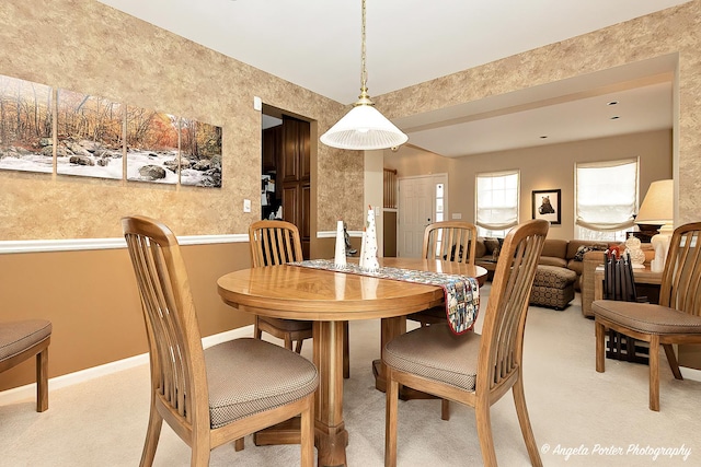 dining room featuring light carpet