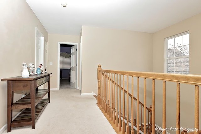 hall featuring light colored carpet