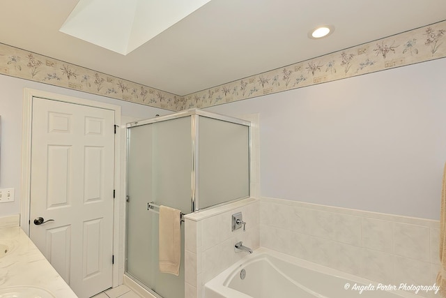 bathroom featuring vanity and independent shower and bath