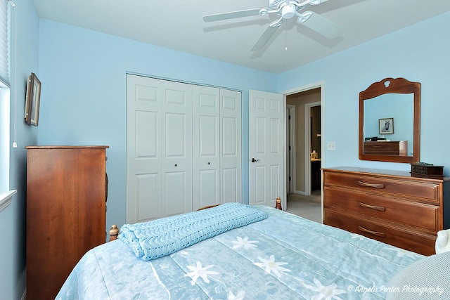 carpeted bedroom with a closet and ceiling fan