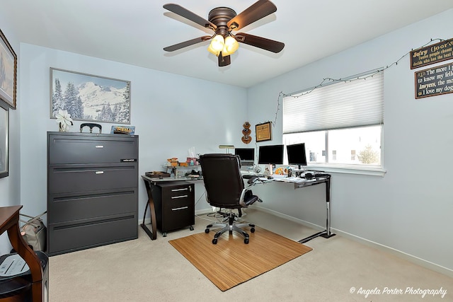 office space featuring ceiling fan and light carpet