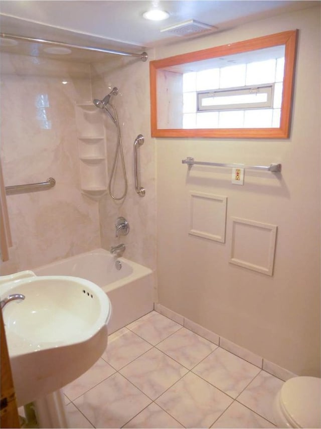 full bathroom featuring tiled shower / bath, tile patterned floors, plenty of natural light, and sink