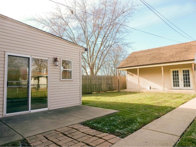 view of yard with french doors and a patio area