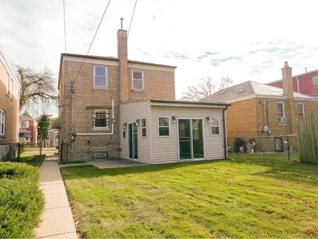 back of property featuring a yard and a patio