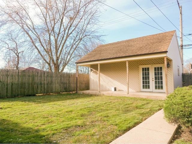 exterior space with a lawn and french doors