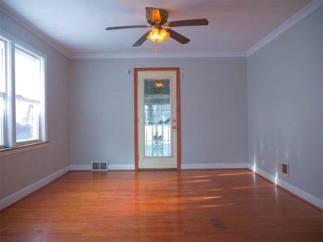 spare room featuring crown molding, ceiling fan, and hardwood / wood-style flooring