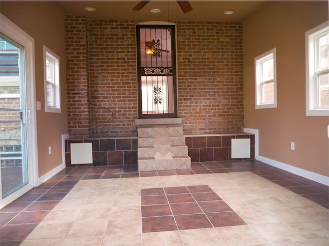 interior space with ceiling fan