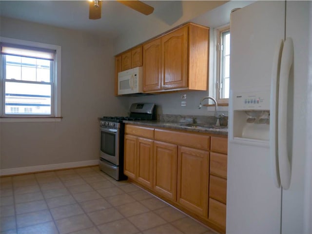 kitchen with ceiling fan, white appliances, sink, and light tile patterned floors