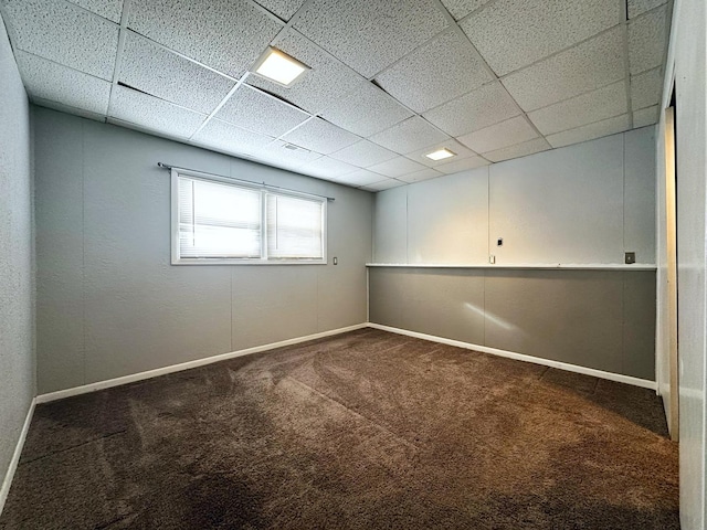 basement featuring carpet flooring and a drop ceiling