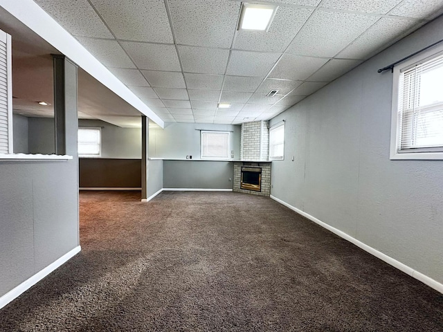 basement with carpet and a brick fireplace