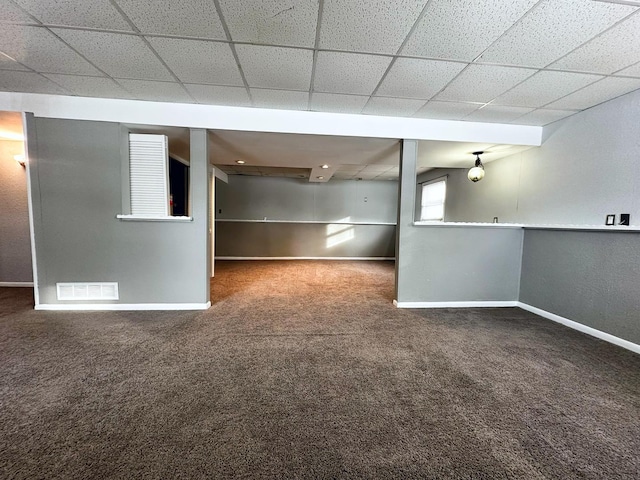 basement featuring dark colored carpet