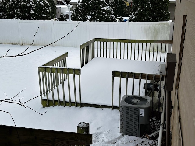 snow covered deck with central air condition unit