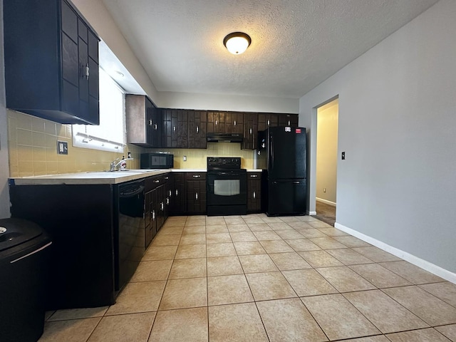 kitchen with dark brown cabinets, a textured ceiling, sink, black appliances, and light tile patterned floors