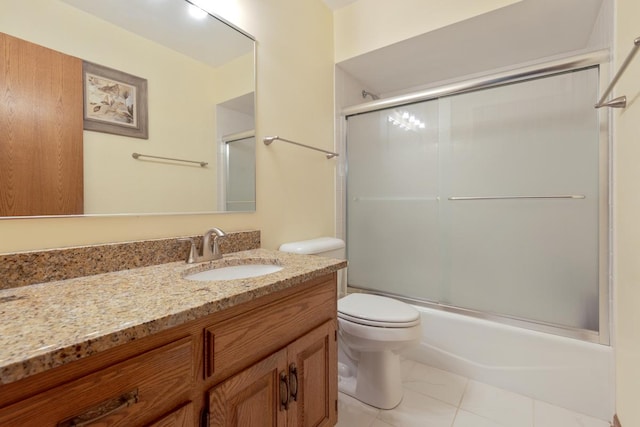 full bathroom featuring vanity, toilet, and bath / shower combo with glass door