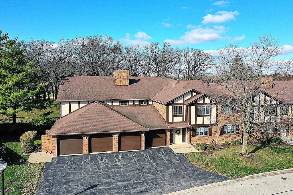 tudor-style house with a front yard