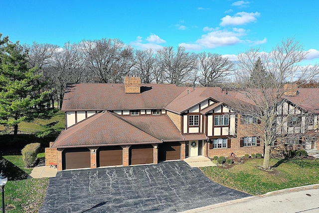 tudor-style house with a front yard