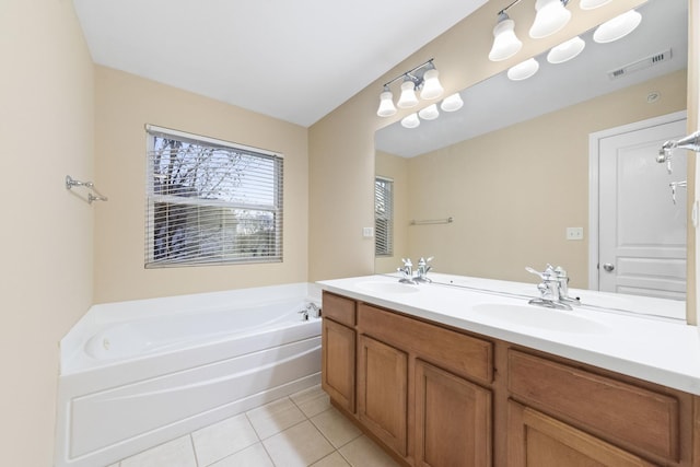 bathroom featuring tile patterned flooring, vanity, and a bathtub