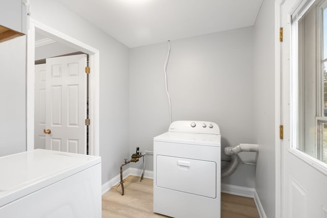 washroom featuring light hardwood / wood-style floors and washer and clothes dryer