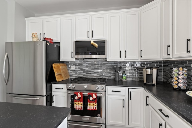 kitchen featuring backsplash, white cabinets, dark stone counters, and stainless steel appliances