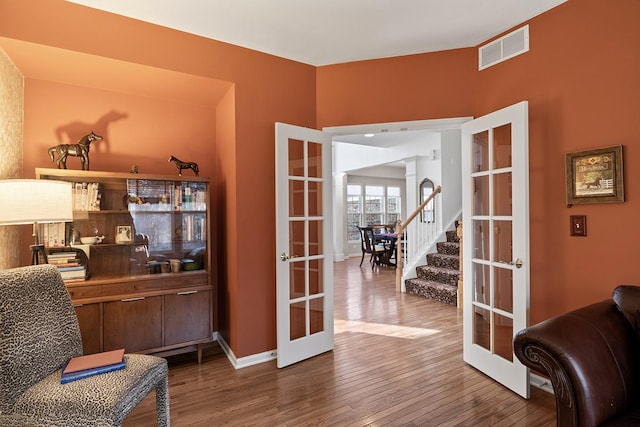 living area featuring hardwood / wood-style flooring and french doors