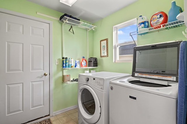 laundry room featuring light tile patterned floors and washer and clothes dryer