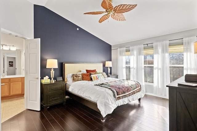 bedroom featuring connected bathroom, vaulted ceiling, ceiling fan, and dark hardwood / wood-style flooring