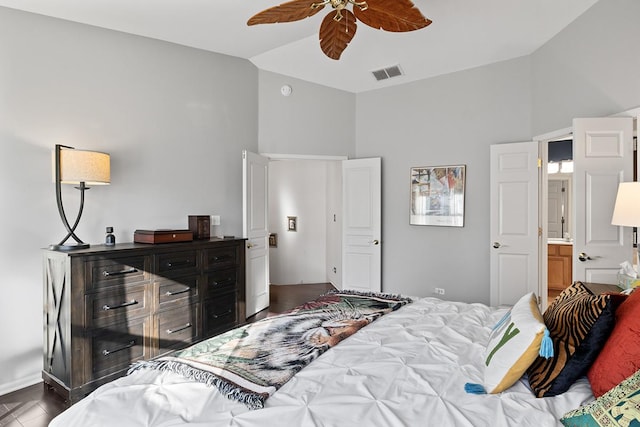 bedroom featuring vaulted ceiling, ensuite bathroom, ceiling fan, and dark wood-type flooring