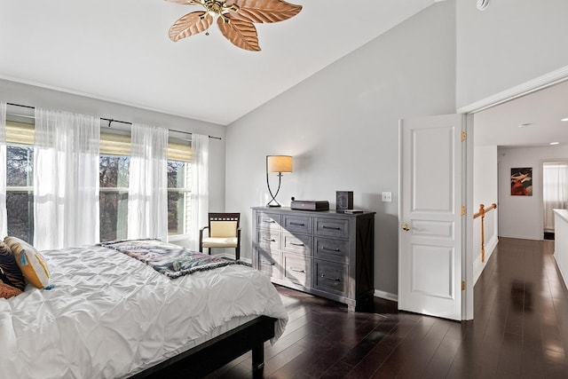 bedroom featuring ceiling fan, dark wood-type flooring, and lofted ceiling