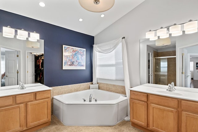 bathroom with tile patterned floors, vanity, lofted ceiling, and shower with separate bathtub