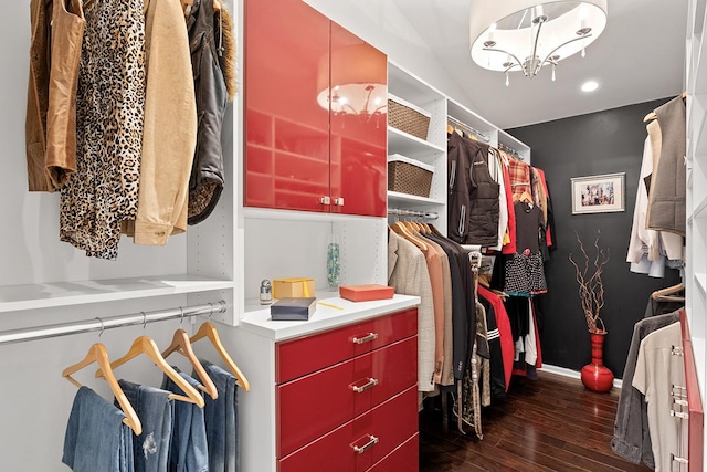 walk in closet with dark wood-type flooring