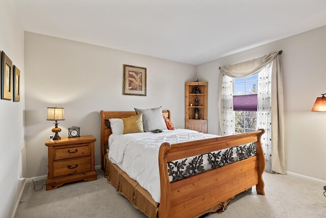 bedroom with light colored carpet