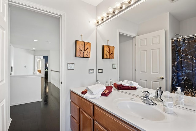 bathroom with vanity and hardwood / wood-style floors