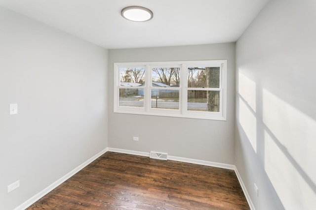 spare room with dark hardwood / wood-style flooring