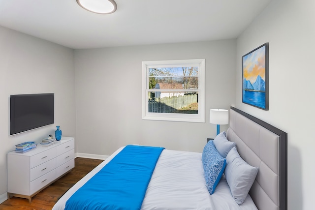 bedroom with dark wood-type flooring