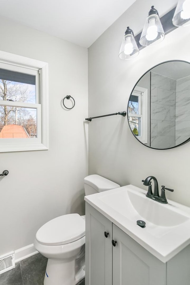 bathroom featuring a wealth of natural light, tile patterned flooring, vanity, and toilet