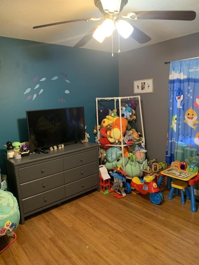 rec room featuring ceiling fan and light hardwood / wood-style floors