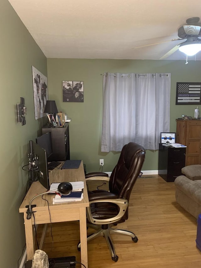 home office featuring ceiling fan and light hardwood / wood-style floors