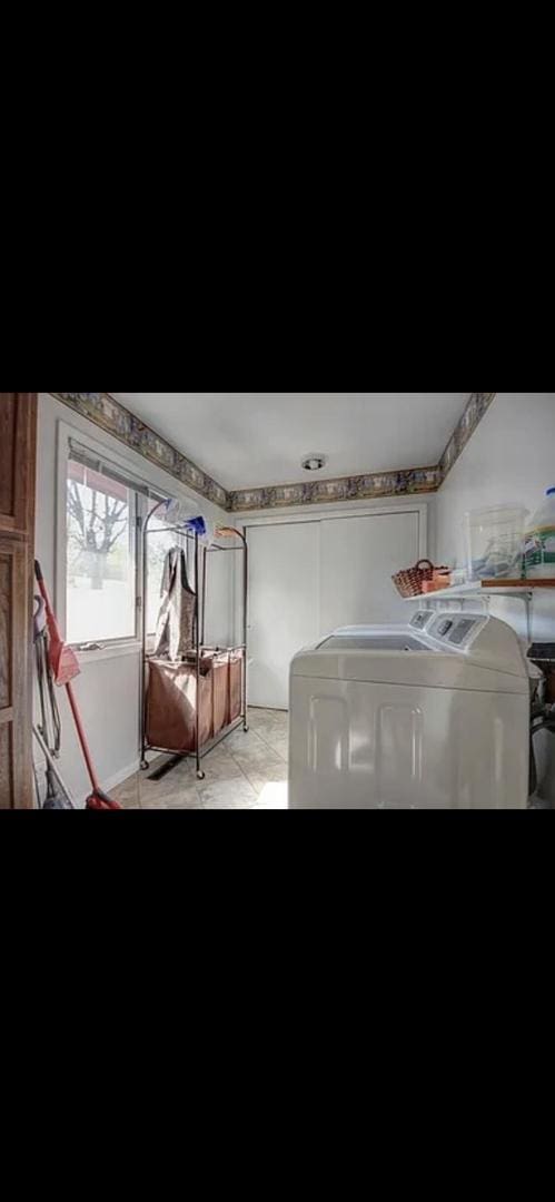 clothes washing area featuring washing machine and clothes dryer