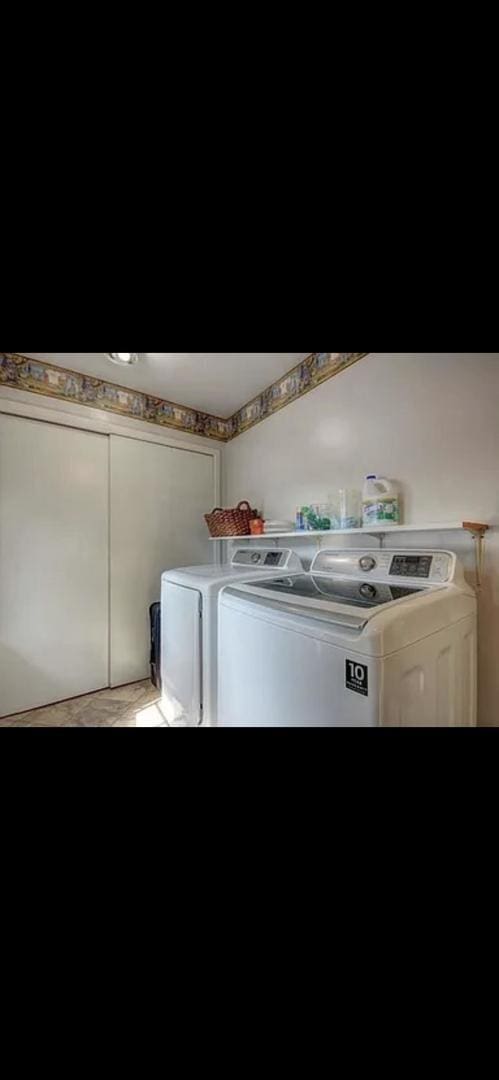 clothes washing area with separate washer and dryer