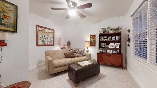 carpeted living room with ceiling fan