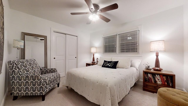 bedroom featuring ceiling fan, light carpet, and a closet