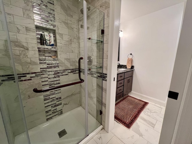 bathroom featuring vanity and a shower with door