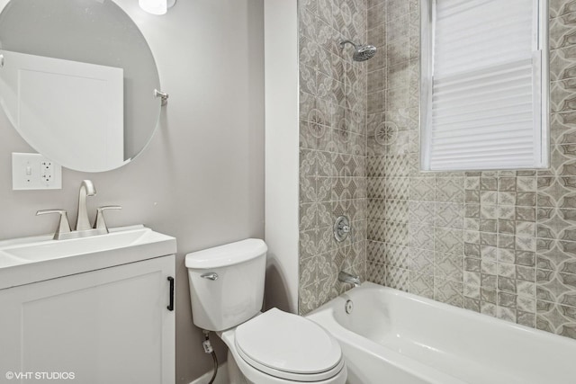 full bathroom featuring toilet, vanity, and tiled shower / bath