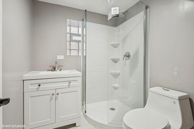 bathroom featuring vanity, toilet, and a shower