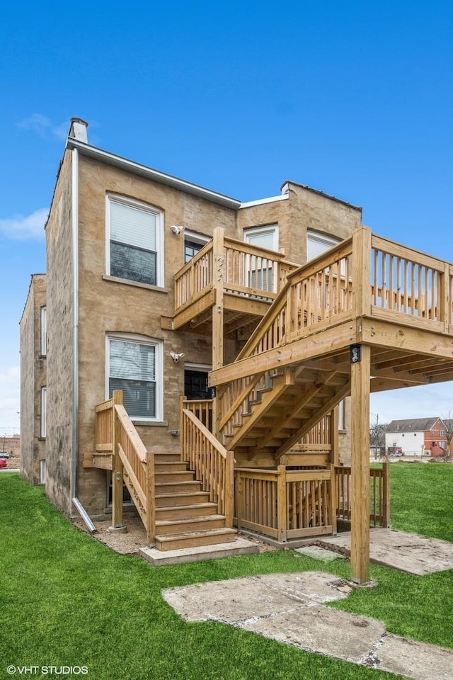 rear view of house featuring a yard, a patio, and a wooden deck