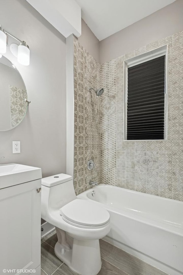 full bathroom featuring vanity, toilet, and tiled shower / bath