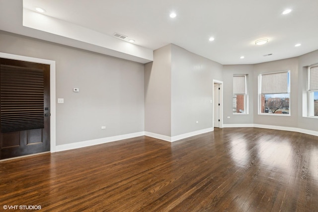 unfurnished living room featuring dark hardwood / wood-style flooring