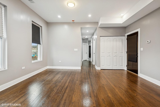 unfurnished room with dark hardwood / wood-style flooring