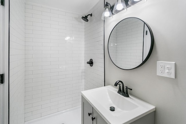 bathroom featuring vanity and tiled shower